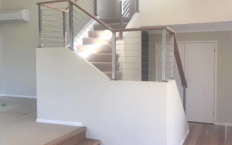 Westleigh Internal Modifications: Stairway. Removed walls, new timber flooring and opened stair case.